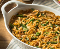 "Freshly baked green bean casserole with crispy onions on top, served in a white dish — a healthy and delicious dinner option."